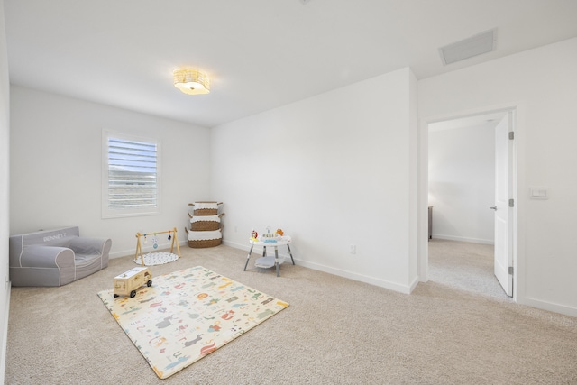 recreation room with light carpet