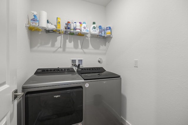 washroom with washing machine and clothes dryer