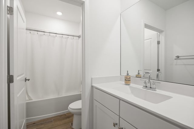 full bathroom featuring hardwood / wood-style floors, vanity, toilet, and shower / bathtub combination with curtain