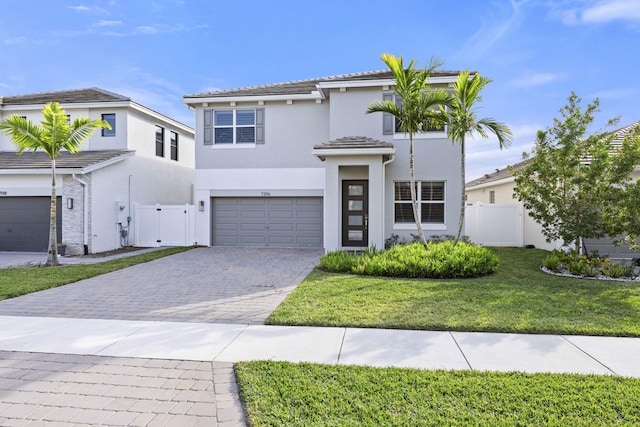 view of front of property featuring a garage and a front lawn