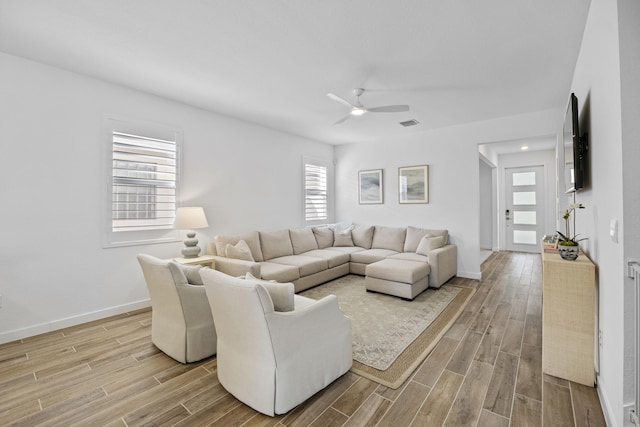 living room with ceiling fan and light hardwood / wood-style floors