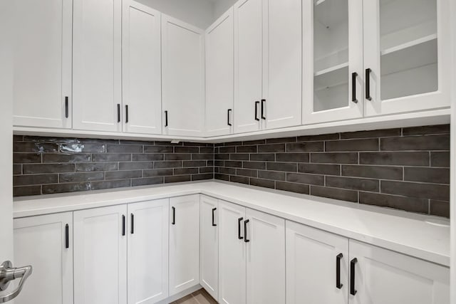 kitchen with white cabinetry and decorative backsplash