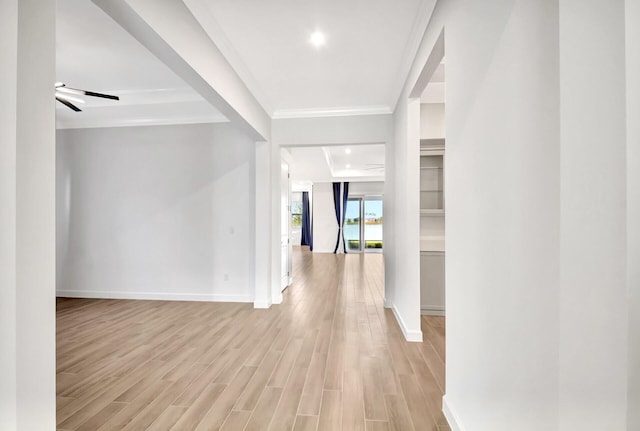 corridor with ornamental molding and light wood-type flooring