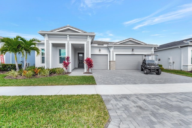 view of front of property with a garage and a front yard