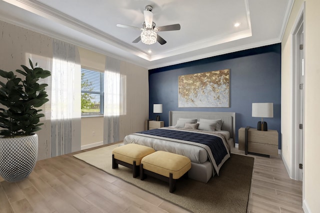 bedroom featuring crown molding, ceiling fan, a tray ceiling, and light hardwood / wood-style flooring