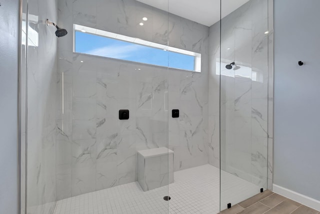 bathroom with a shower with door