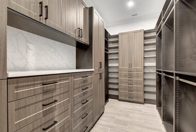 spacious closet with light hardwood / wood-style floors