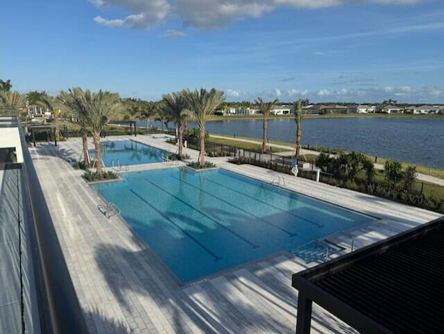 view of swimming pool featuring a water view