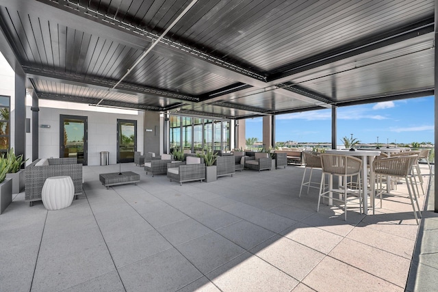 view of patio / terrace with a bar and outdoor lounge area