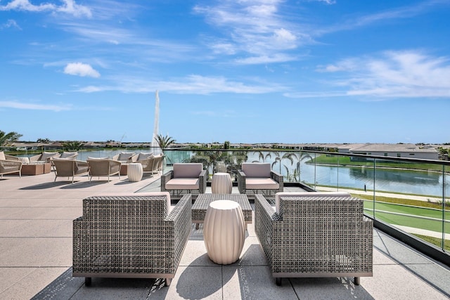 view of patio featuring a water view and outdoor lounge area