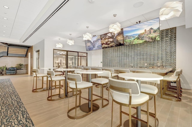 interior space featuring light hardwood / wood-style floors and bar area