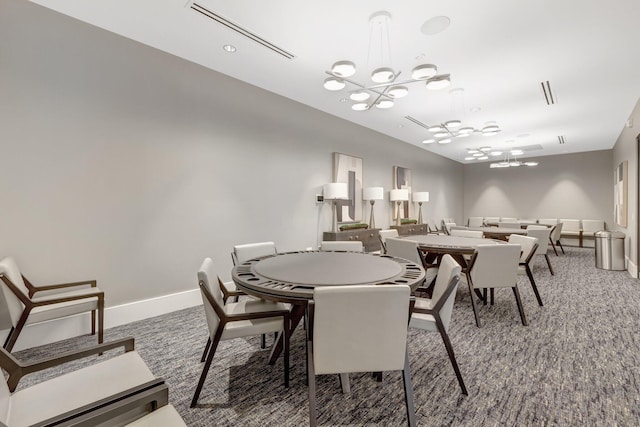 carpeted dining area featuring a notable chandelier