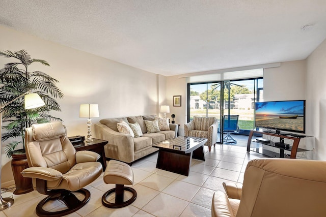 living room featuring light tile patterned flooring and a textured ceiling