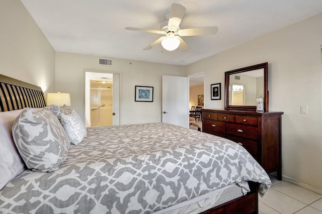 bedroom featuring a spacious closet, ceiling fan, and light tile patterned floors