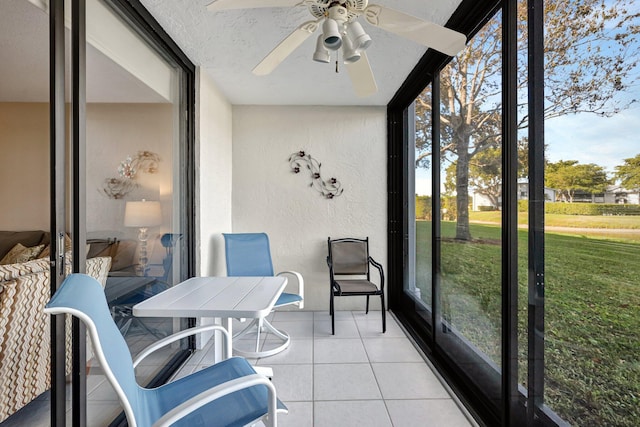 sunroom / solarium featuring ceiling fan