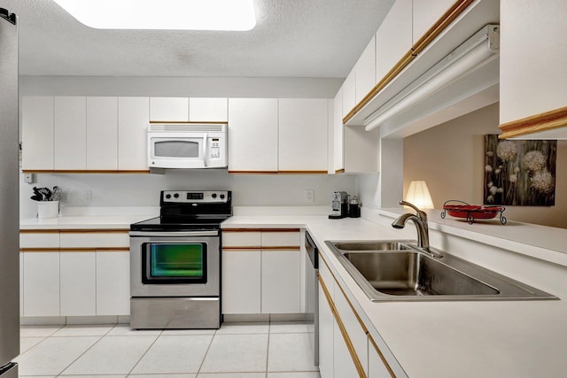 kitchen with white cabinetry, stainless steel appliances, and a textured ceiling