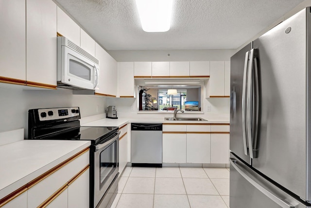 kitchen featuring sink, white cabinetry, and stainless steel appliances