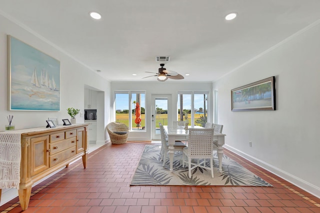 dining space with tile patterned floors, ceiling fan, and ornamental molding