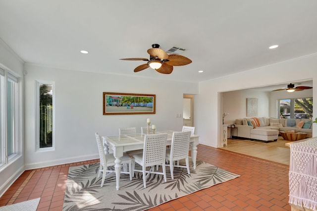 dining area with ceiling fan and crown molding