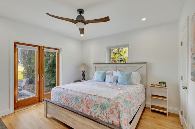 bedroom featuring recessed lighting, wood finished floors, access to exterior, and multiple windows