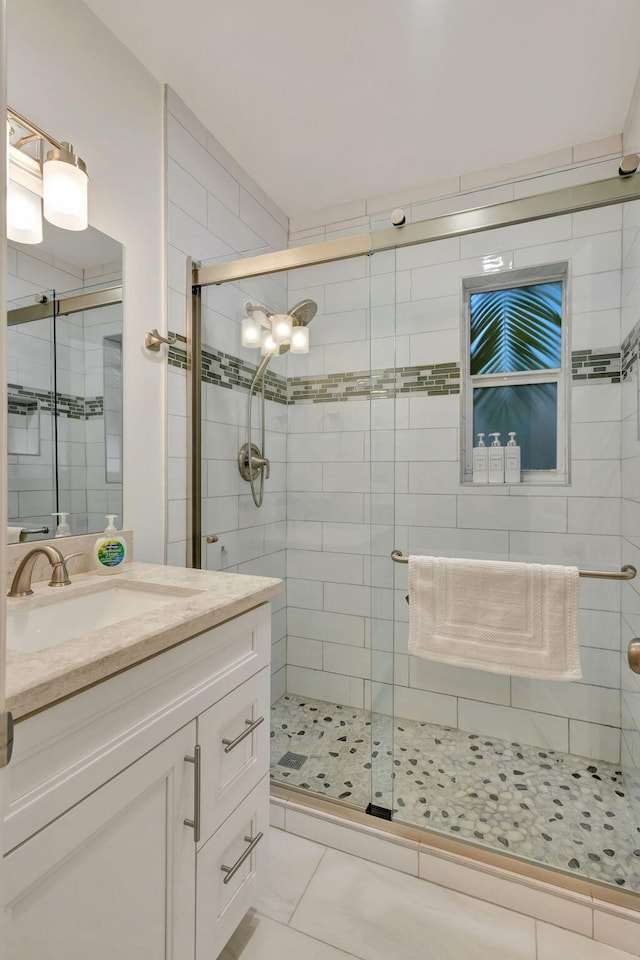 bathroom featuring tile patterned floors, vanity, and an enclosed shower