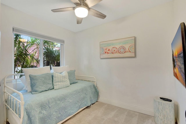carpeted bedroom featuring ceiling fan, baseboards, and radiator heating unit