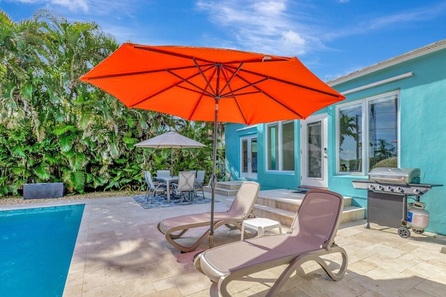 view of patio featuring an outdoor pool, outdoor dining space, french doors, and area for grilling
