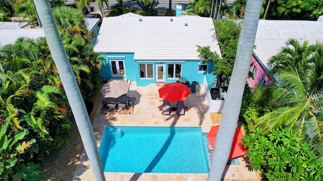 view of swimming pool with french doors and a patio