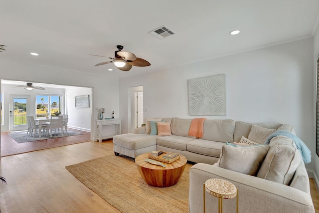 living room featuring ceiling fan, wood finished floors, visible vents, and recessed lighting