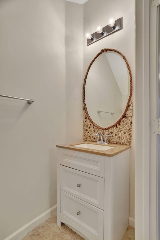 bathroom with tile patterned flooring, vanity, and tasteful backsplash