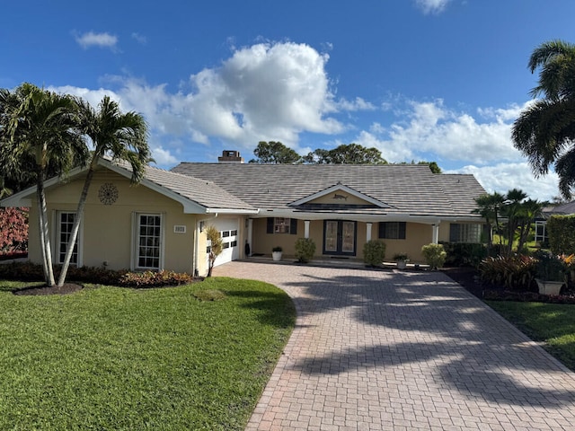 single story home with a front yard and french doors