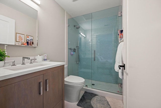 bathroom featuring toilet, vanity, and walk in shower