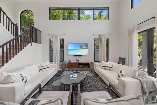 living room featuring a wealth of natural light and a towering ceiling