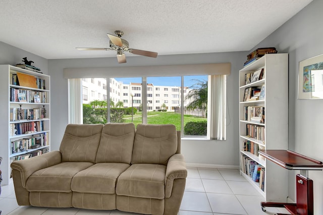 living area featuring a textured ceiling, a healthy amount of sunlight, and light tile patterned flooring