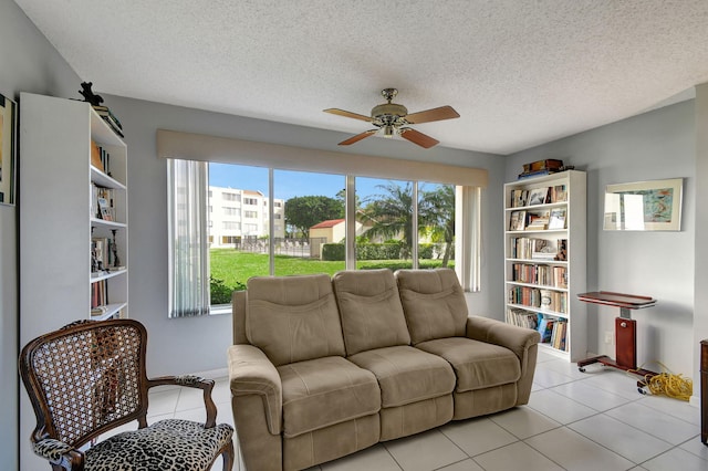 tiled living room with a textured ceiling and ceiling fan