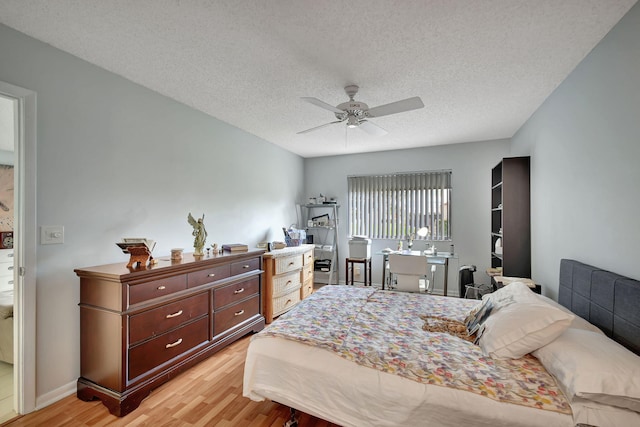 bedroom with a textured ceiling, light wood-type flooring, and ceiling fan