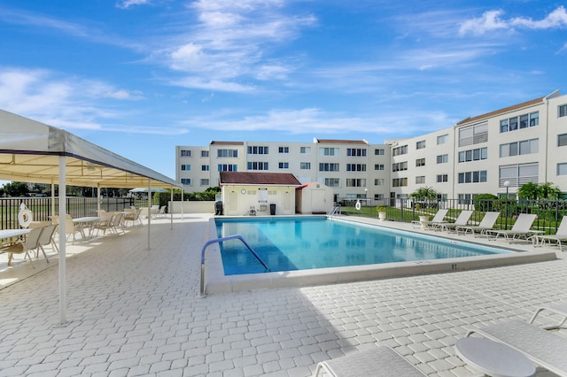 view of swimming pool with an outbuilding and a patio