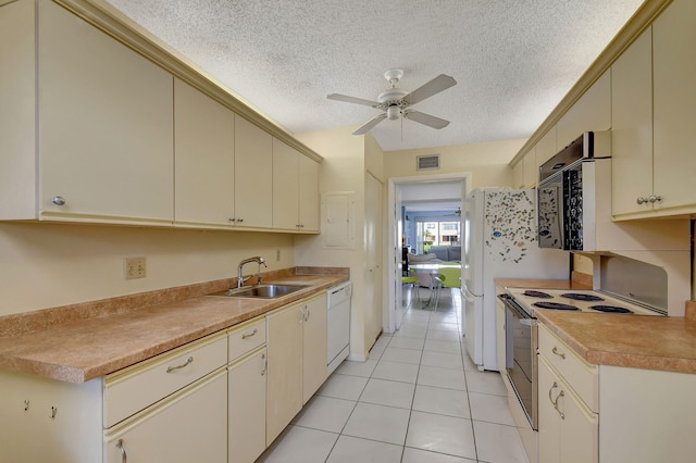 kitchen with cream cabinetry, white dishwasher, stainless steel electric stove, and sink