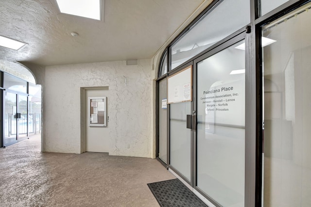 hallway with a textured ceiling