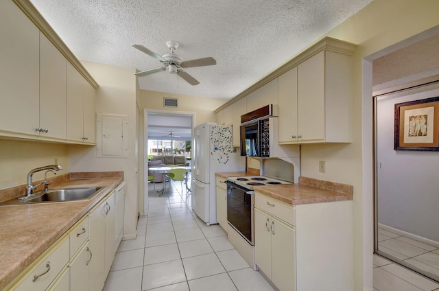 kitchen with ceiling fan, cream cabinets, white appliances, and sink