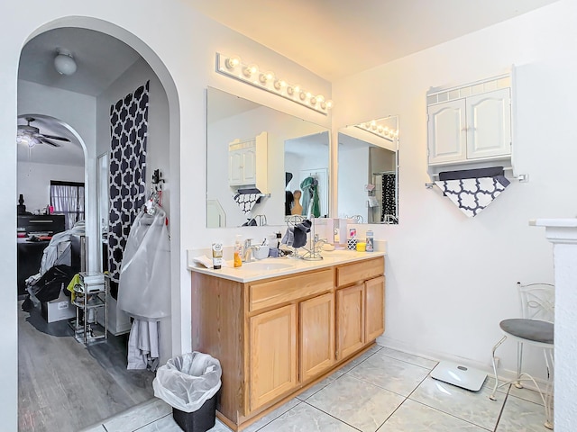 bathroom featuring ceiling fan, wood-type flooring, and vanity