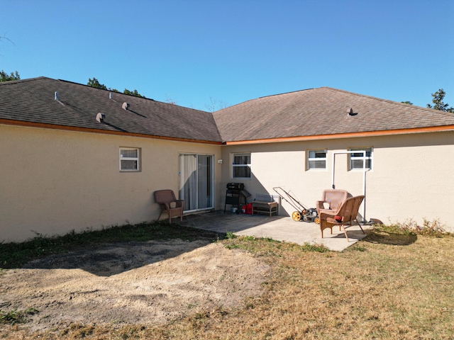 back of house featuring a yard and a patio