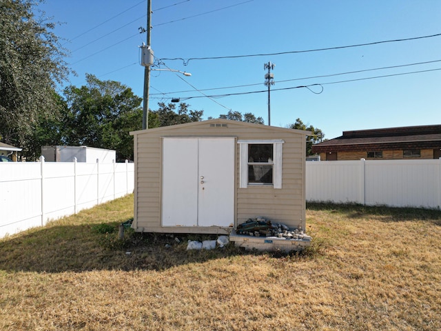 view of outbuilding featuring a lawn