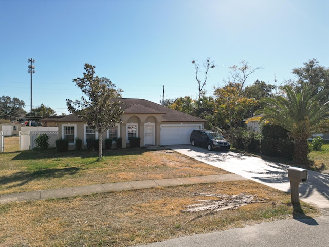 view of front of house with a front yard and a garage