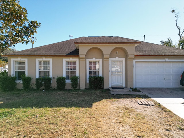 view of front facade featuring a front yard and a garage