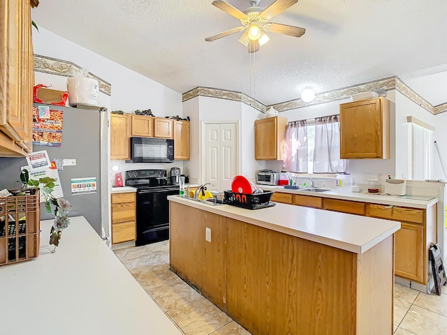 kitchen featuring a textured ceiling, ceiling fan, sink, black appliances, and lofted ceiling