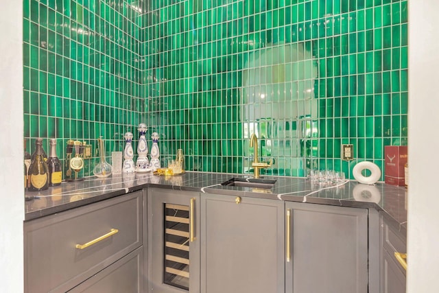 interior space featuring wine cooler, tile walls, and indoor wet bar