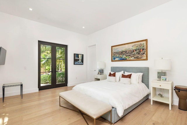 bedroom with french doors and light hardwood / wood-style flooring