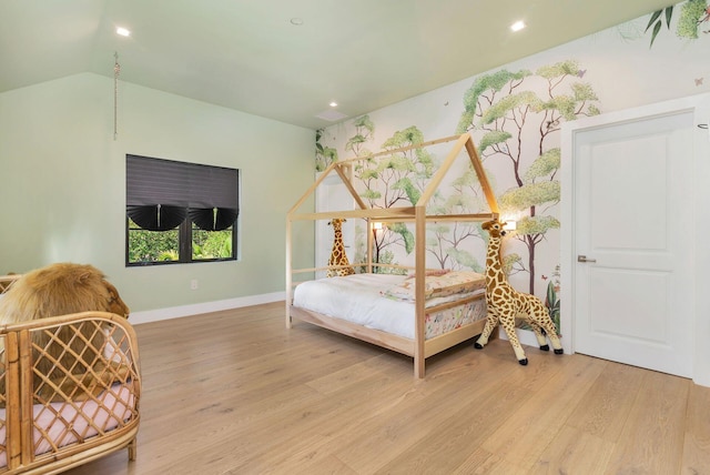 bedroom featuring light hardwood / wood-style floors and vaulted ceiling