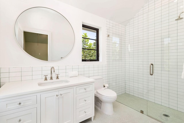 bathroom featuring vanity, a shower with door, tile patterned flooring, toilet, and tile walls